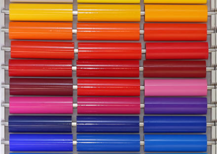 A bright wall of vinyl in yellows, oranges, reds, pinks and blues for apparel decoration